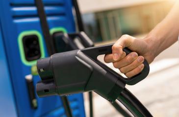 woman holding a DC - CCS type 2 EV charging connector at EV char : Stock Photo or Stock Video Download rcfotostock photos, images and assets rcfotostock | RC Photo Stock.: