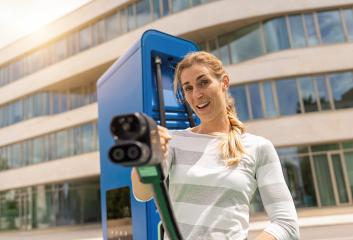 woman holding a DC CCS2 EV charging connector on a Hypercharger - Stock Photo or Stock Video of rcfotostock | RC Photo Stock