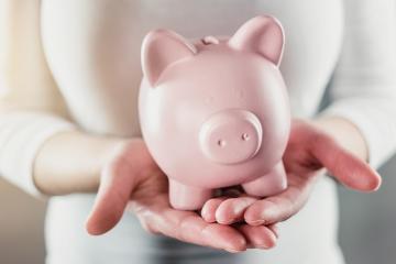 woman holding a piggy bank - money investments concept image- Stock Photo or Stock Video of rcfotostock | RC Photo Stock