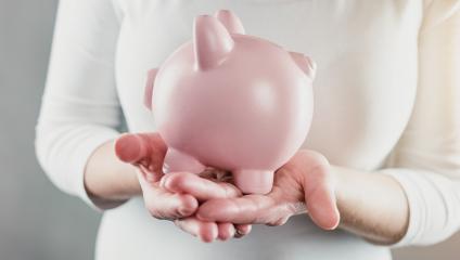 woman holding a piggy bank carefully - business money concept- Stock Photo or Stock Video of rcfotostock | RC Photo Stock