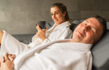 Woman holding mug of hot tea and smiling, man with closed eyes relaxing in spa : Stock Photo or Stock Video Download rcfotostock photos, images and assets rcfotostock | RC Photo Stock.: