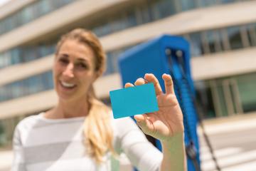 Woman holding Nfc or Rfid card on a  Hypercharger or Supercharge : Stock Photo or Stock Video Download rcfotostock photos, images and assets rcfotostock | RC Photo Stock.: