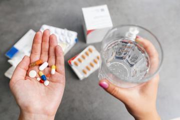 woman Holding Pills and Glass of Water for medication- Stock Photo or Stock Video of rcfotostock | RC-Photo-Stock