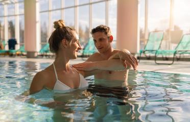 woman in a white swimsuit smiles at a male trainer during a shou- Stock Photo or Stock Video of rcfotostock | RC Photo Stock