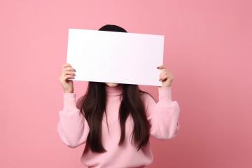 Woman in pink sweater holding a blank white sign in front of her face : Stock Photo or Stock Video Download rcfotostock photos, images and assets rcfotostock | RC Photo Stock.: