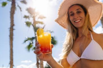 Woman in white bikini and straw hat offering a tropical cocktail, sunny sky with palm trees. Party and summer holidays concept image on a caribbean island. : Stock Photo or Stock Video Download rcfotostock photos, images and assets rcfotostock | RC Photo Stock.: