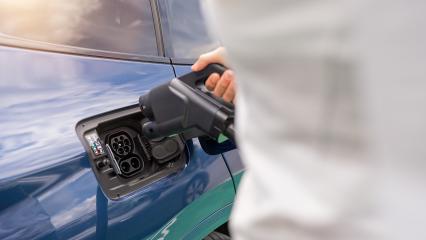 Woman inserting a DC CCS2 EV charging connector into electric ca- Stock Photo or Stock Video of rcfotostock | RC Photo Stock