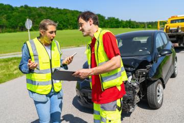 Woman is surprised at the high cost of the towing service with a tow truck and damaged car in the background : Stock Photo or Stock Video Download rcfotostock photos, images and assets rcfotostock | RC Photo Stock.: