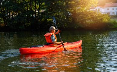 woman joyfully kayaks on a serene river at sunset, surrounded by lush greenery at summer in germany. Kayak Water Sports concept image- Stock Photo or Stock Video of rcfotostock | RC Photo Stock