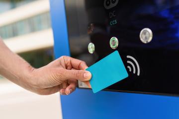 Woman pays for charging on a  Hypercharger or Supercharger with - Stock Photo or Stock Video of rcfotostock | RC Photo Stock