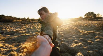woman pulling guy's hand walking on board walk in a bog landscape on a bright sunset. Follow me - POV of carefree modern life Concept image- Stock Photo or Stock Video of rcfotostock | RC Photo Stock