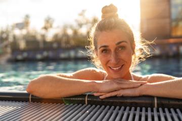 Woman relaxing in a pool at a hotel or spa resort, leaning on ed- Stock Photo or Stock Video of rcfotostock | RC Photo Stock