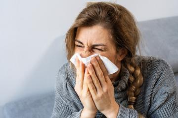 Woman sneezing in a tissue in the living room. Flu, Medicine and healthcare concept image : Stock Photo or Stock Video Download rcfotostock photos, images and assets rcfotostock | RC Photo Stock.: