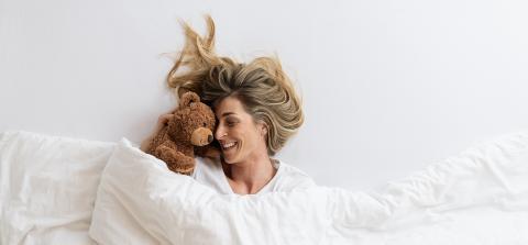 woman that cuddles with her teddy bear sleeping on white bed and lying under blanket, Top view,  copyspace for your individual text.- Stock Photo or Stock Video of rcfotostock | RC Photo Stock