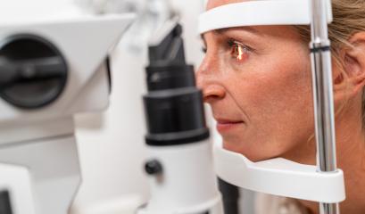 Woman undergoing an eye examination with a focus on her illuminated eye using a slit lamp at the ophthalmology clinic. Close-up photo. Healthcare and medicine concept- Stock Photo or Stock Video of rcfotostock | RC Photo Stock