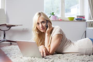 Woman using laptop and telephone on carpet- Stock Photo or Stock Video of rcfotostock | RC Photo Stock