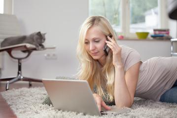 Woman using laptop and telephone on carpet- Stock Photo or Stock Video of rcfotostock | RC-Photo-Stock