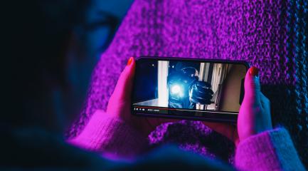 Woman watching crime movie on mobile phone with imaginary video player service. Online movie stream with smartphone. - Stock Photo or Stock Video of rcfotostock | RC Photo Stock