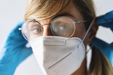 Woman wearing N95 FFP2 an anti virus protection mask and glasses are fogged up to prevent others from corona COVID-19 and SARS cov 2 infection- Stock Photo or Stock Video of rcfotostock | RC Photo Stock
