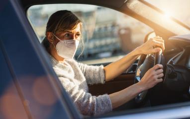 woman with a N95 FFP2 anti virus mask sitting in a car and looks around, protective mask against coronavirus, driver on a city street during a coronavirus outbreak, covid-19.- Stock Photo or Stock Video of rcfotostock | RC Photo Stock