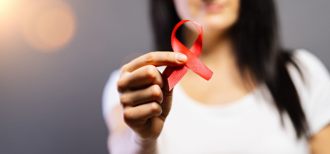 Woman with red AIDS or HIV ribbon. Breast cancer awareness concept - Stock Photo or Stock Video of rcfotostock | RC Photo Stock