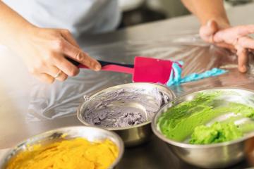 women in pastry bakery as confectioner prepares different cream colors for the icing bag to pipe muffin topping : Stock Photo or Stock Video Download rcfotostock photos, images and assets rcfotostock | RC Photo Stock.:
