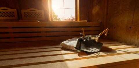 Wooden sauna with benches, window, towel, metal bucket, ladle, and felt hats in a finnish sauna. Spa wellness hotel concept image.- Stock Photo or Stock Video of rcfotostock | RC Photo Stock