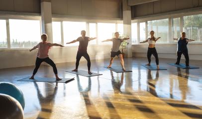 Yoga class practicing warrior pose, sunlit studio with reflective flooring : Stock Photo or Stock Video Download rcfotostock photos, images and assets rcfotostock | RC Photo Stock.: