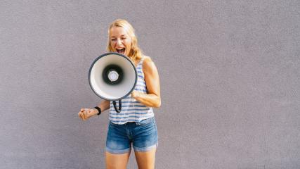 young blond woman shouting on a megaphone. copyspace for your individual text. business concept image- Stock Photo or Stock Video of rcfotostock | RC-Photo-Stock