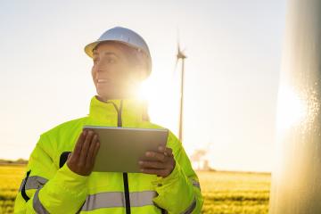 Young female engineer holding tablet looking and checking wind turbines at field : Stock Photo or Stock Video Download rcfotostock photos, images and assets rcfotostock | RC Photo Stock.: