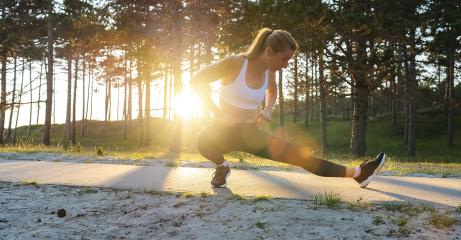 Young female workout before fitness training session at beach. Healthy young woman warming up outdoors. She is stretches her legs a path at sunrise.- Stock Photo or Stock Video of rcfotostock | RC Photo Stock
