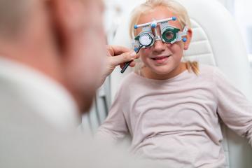 Young girl in a vision test or eye exam for eyesight by doctor, - Stock Photo or Stock Video of rcfotostock | RC Photo Stock
