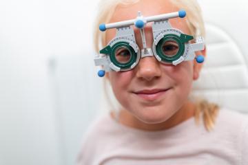 Young girl wearing trial frame glasses during an optometrist. ha- Stock Photo or Stock Video of rcfotostock | RC Photo Stock
