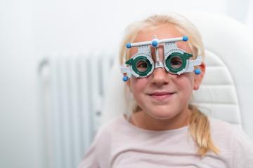 Young girl wearing trial frame glasses during an optometry test
 : Stock Photo or Stock Video Download rcfotostock photos, images and assets rcfotostock | RC Photo Stock.: