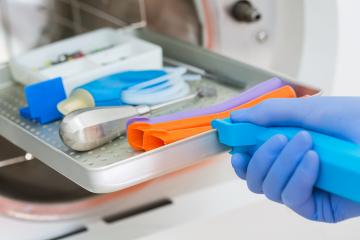 Young male dentist places medical autoclave for sterilising surgical and other instruments- Stock Photo or Stock Video of rcfotostock | RC Photo Stock