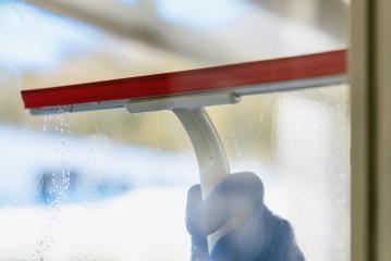 young man is using a rag and squeegee while cleaning windows. : Stock Photo or Stock Video Download rcfotostock photos, images and assets rcfotostock | RC-Photo-Stock.:
