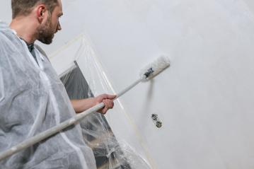 young man painting a wall with roller in with color. do it yourself concept image- Stock Photo or Stock Video of rcfotostock | RC Photo Stock