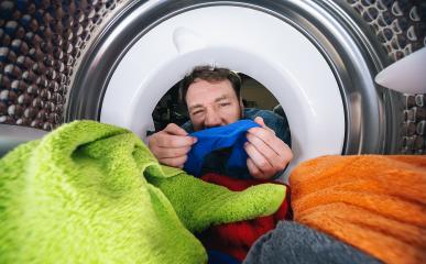 Young man Reaching Inside a washing machine or dryer doing laundry View from the inside- Stock Photo or Stock Video of rcfotostock | RC Photo Stock