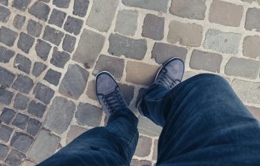 Young man standing in at the street in a oldtown in casually dressed sneakers, Point of view shot- Stock Photo or Stock Video of rcfotostock | RC Photo Stock