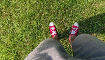 Young man standing in freshly grass lawn in casually dressed red sneakers, Point of view shot- Stock Photo or Stock Video of rcfotostock | RC Photo Stock