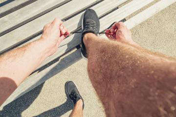 Young man tying laces of running shoes before training : Stock Photo or Stock Video Download rcfotostock photos, images and assets rcfotostock | RC Photo Stock.: