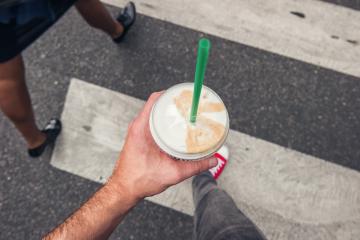 Young man walking on zebra crossing in the city with coffee to go in his hand, point of view perspective. : Stock Photo or Stock Video Download rcfotostock photos, images and assets rcfotostock | RC Photo Stock.: