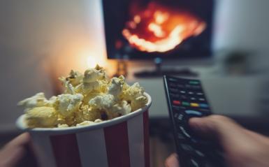 young man watching a movie with popcorn and remote controller, Point of view shot - Stock Photo or Stock Video of rcfotostock | RC Photo Stock