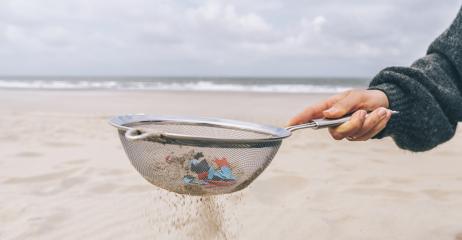 Young woman cleaning microplastics from sand on the beach, Environmental problem, pollution, ecolosystem and climate change warning concept - Stock Photo or Stock Video of rcfotostock | RC Photo Stock