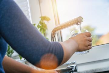 young woman gaining a glass of clean tap water in the kitchen in front of the window- Stock Photo or Stock Video of rcfotostock | RC Photo Stock