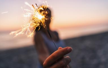 Young woman stands on beach with sparkler in sunset light- Stock Photo or Stock Video of rcfotostock | RC-Photo-Stock