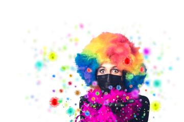 young woman with colorful wig blows corona viruses into the crowd for carnival, instead of confetti,carnival 2021 with corona and ffp2 mask : Stock Photo or Stock Video Download rcfotostock photos, images and assets rcfotostock | RC Photo Stock.: