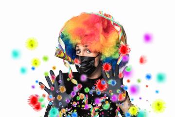 young woman with colorful wig blows corona viruses into the crowd for carnival, instead of confetti,carnival 2021 with corona and ffp2 mask : Stock Photo or Stock Video Download rcfotostock photos, images and assets rcfotostock | RC Photo Stock.: