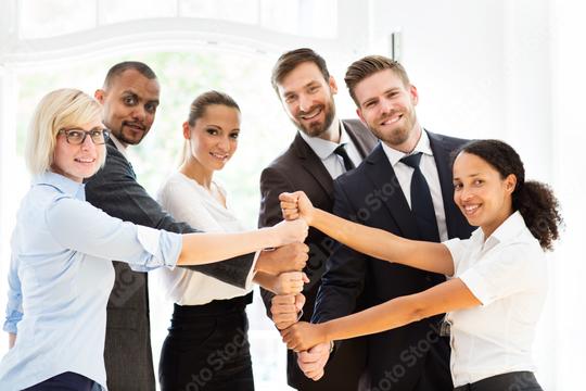 A diverse group of business professionals smiling and collaborating, symbolizing teamwork, unity, and success in a bright office setting  : Stock Photo or Stock Video Download rcfotostock photos, images and assets rcfotostock | RC Photo Stock.:
