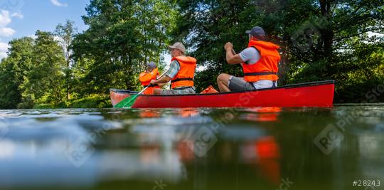 A family of three—a mother, father, and daughter—in life jackets paddling a red canoe on a peaceful river in bavarai, germany. Family on kayak ride. Wild nature and water fun on summer vacation.  : Stock Photo or Stock Video Download rcfotostock photos, images and assets rcfotostock | RC Photo Stock.: